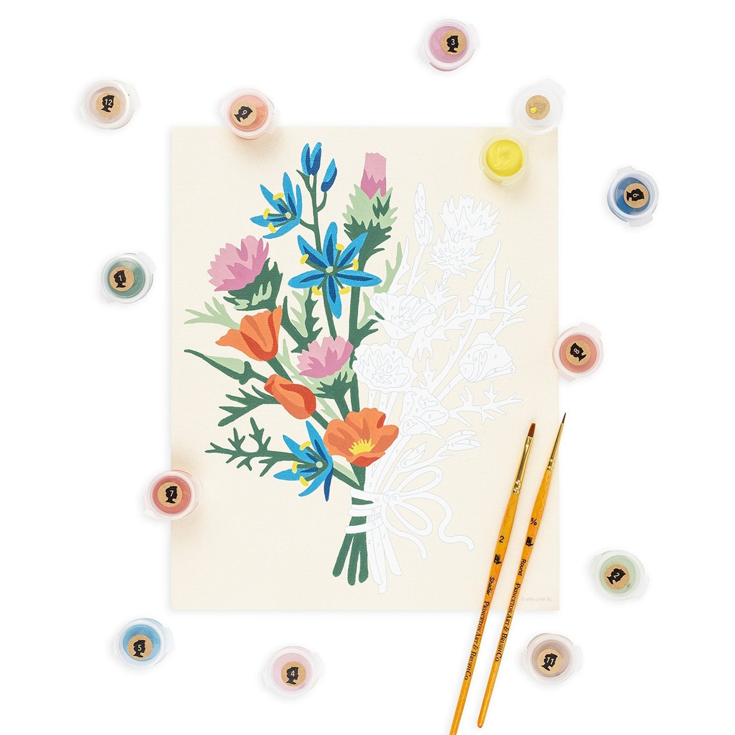 Floral illustration on a card with paintbrushes and paintstones around on a white background